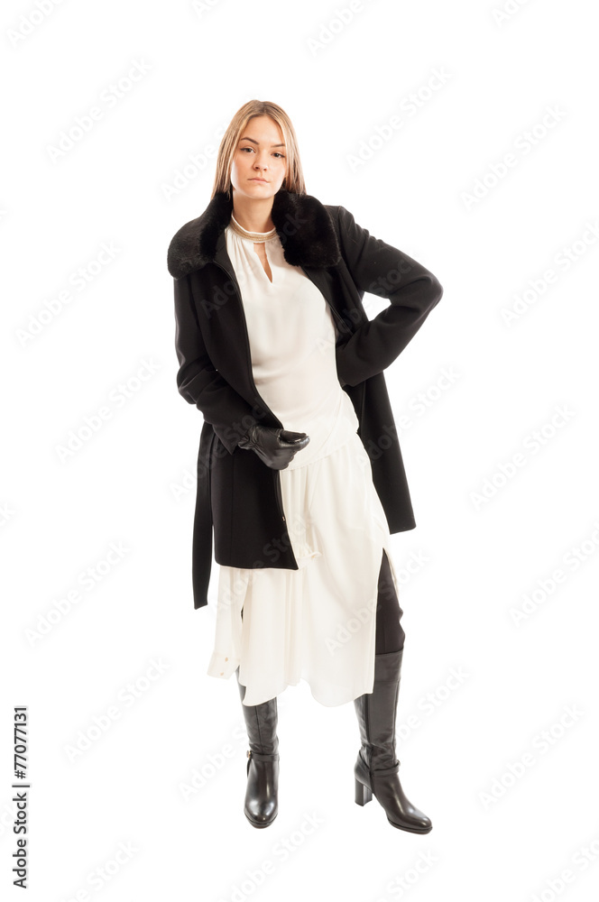 Female model wearing black wool coat on white dress Female model wearing black wool coat on white dress