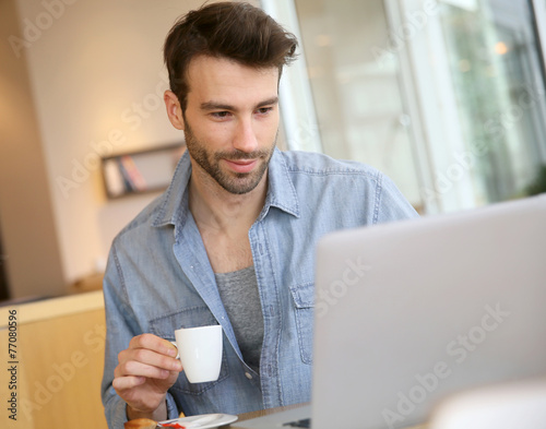 Man working on laptop computer from home