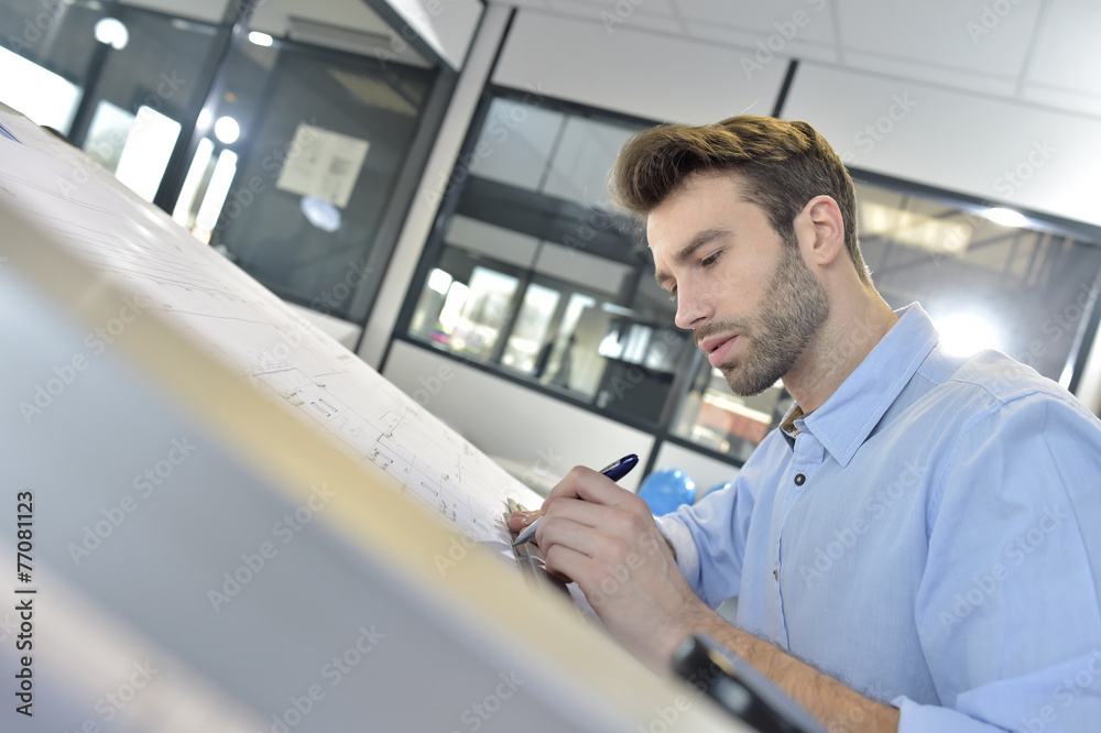 Fototapeta premium Architect designing on drafting table