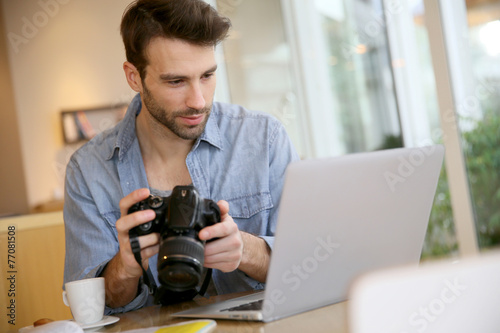 Student in photography working with laptop