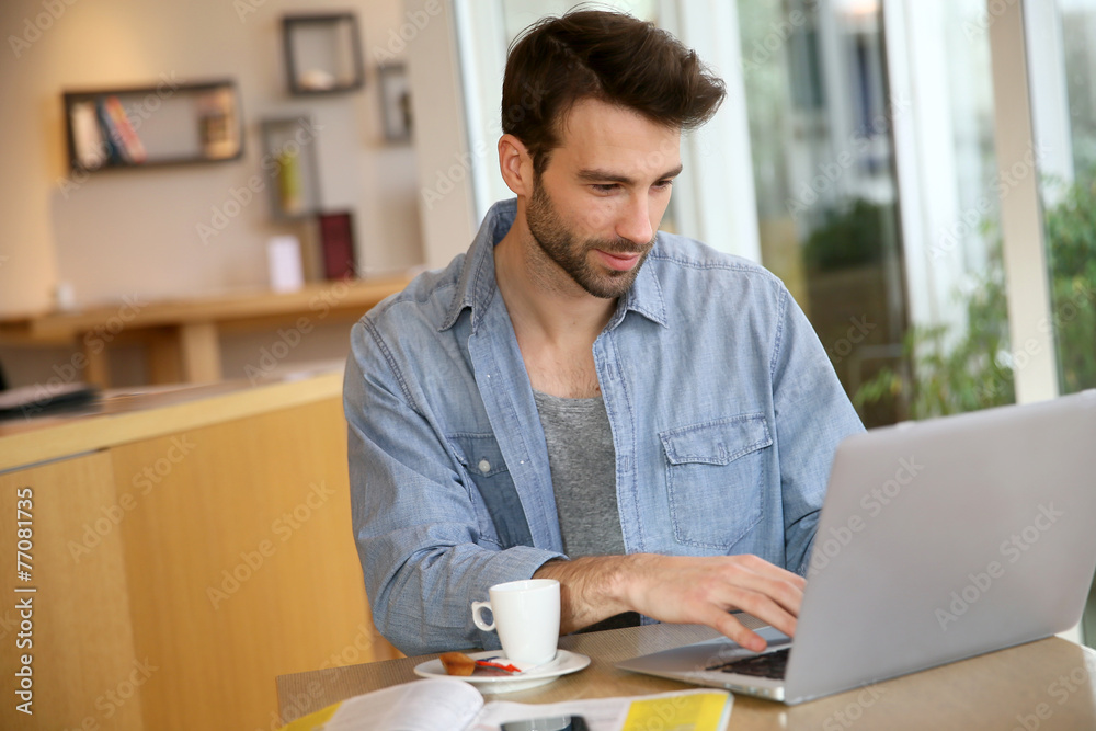 Man working on laptop computer from home Man working on laptop computer from home