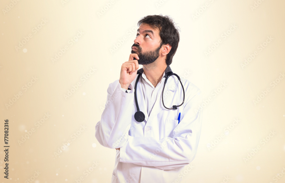 Doctor thinking over isolated white background Doctor thinking over isolated white background