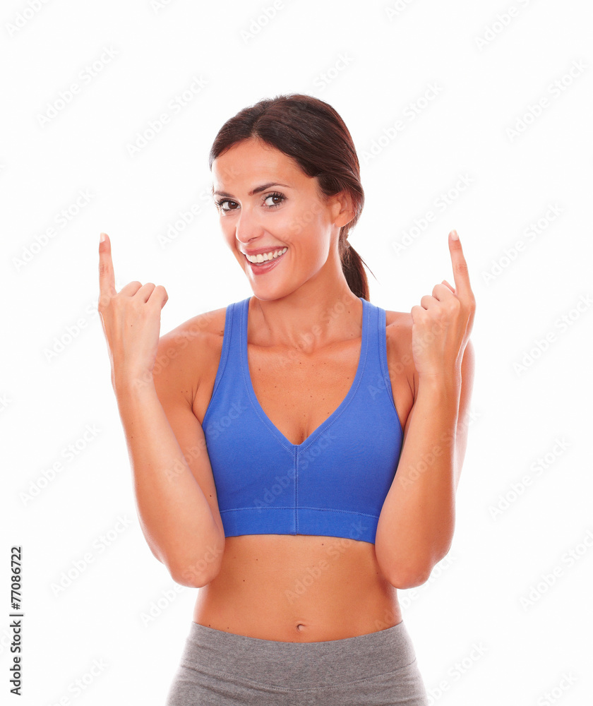 Latin adult woman exercising pointing up