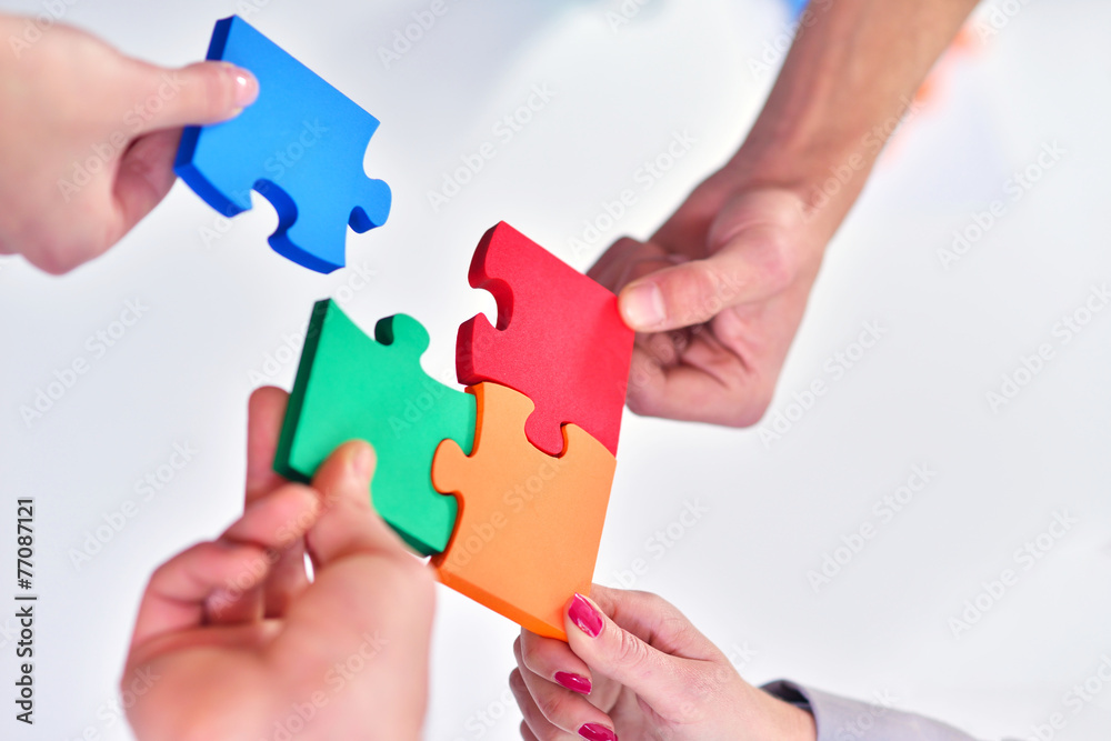 Group of business people assembling jigsaw puzzle and represent Group of business people assembling jigsaw puzzle and represent