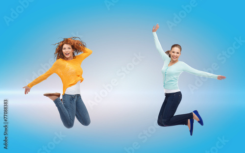 smiling young women jumping in air
