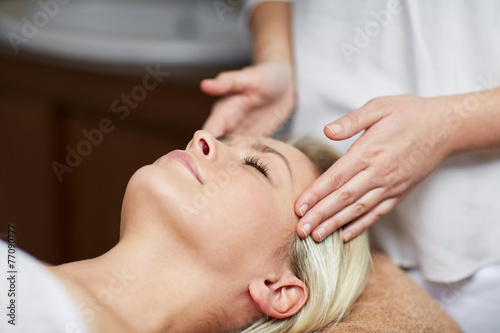 close up of woman having face massage in spa