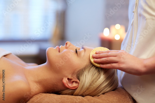 close up of woman having face massage in spa