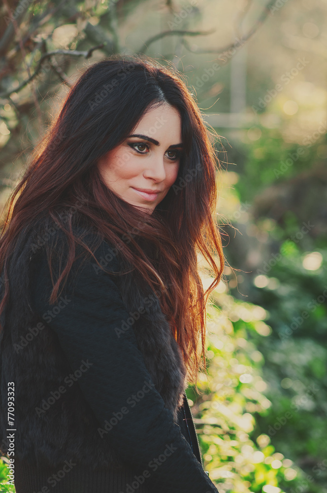 Beautiful young woman walking in the park, selective focus Beautiful young woman walking in the park, selective focus