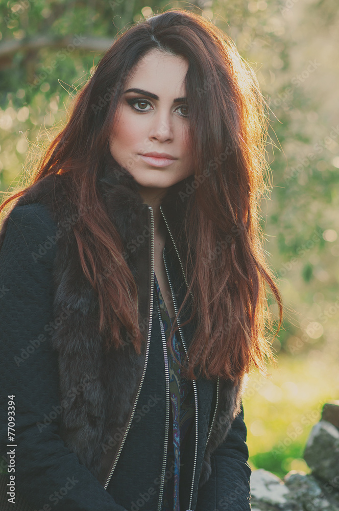 Fototapeta premium Beautiful young woman walking in the park, selective focus