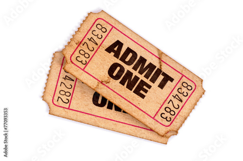 Two old vintage stained and damaged admit one movie ticket stub isolated white background photo