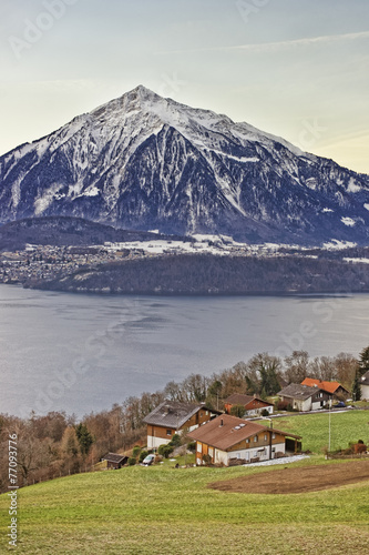 Panoramic view of Swiss Niesen mountain near the Thun lake in wi
