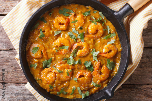 Shrimp in curry sauce in a pan close-up horizontal top view