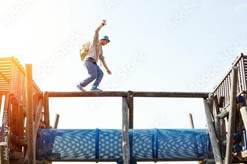 traveler walking balance over wooden construction