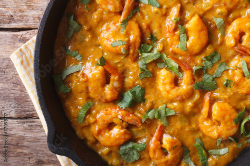Prawns in curry sauce close-up. horizontal view from above