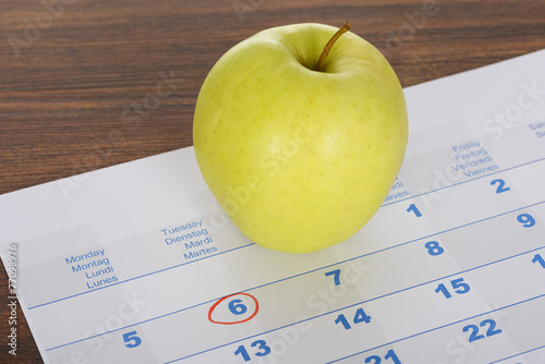 Apple On Calendar Marked With Marker