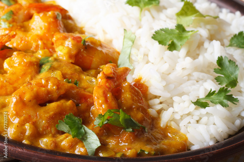 Shrimps in curry sauce with rice and cilantro macro horizontal