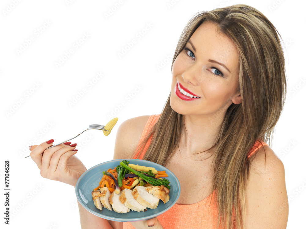 Young Woman Eating Chicken with Mixed Vegetables Young Woman Eating Chicken with Mixed Vegetables
