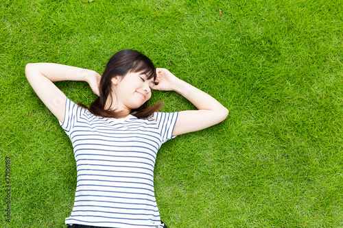 young asian woman lying on the lawn