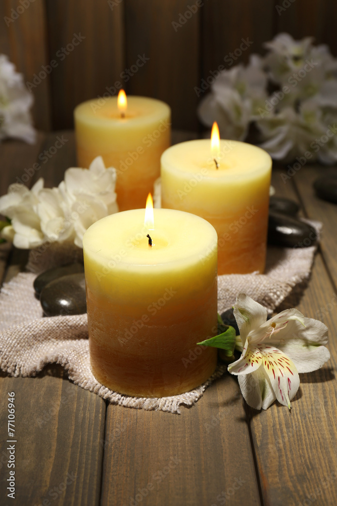 Beautiful candles with flowers on wooden background Beautiful candles with flowers on wooden background