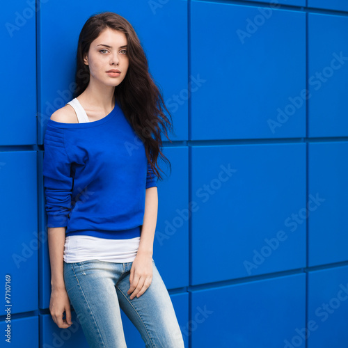Beautiful brunette woman with blue geometric background