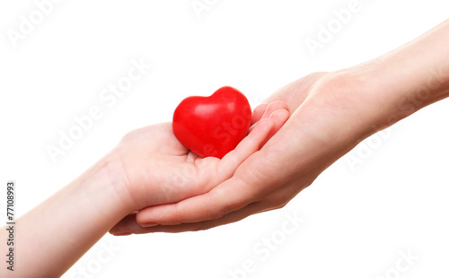 Heart in child and mother hands isolated on white