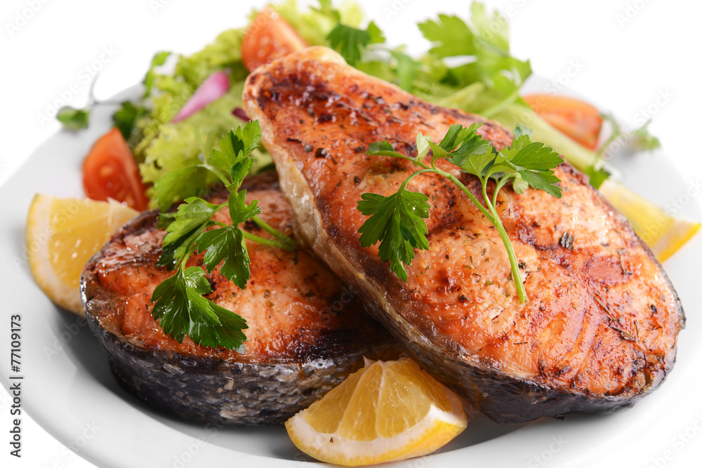 Tasty baked fish on plate close-up Tasty baked fish on plate close-up