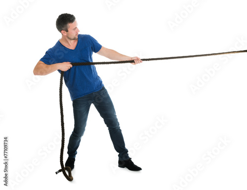 Fotografie Portrait Of A Man Pulling Rope