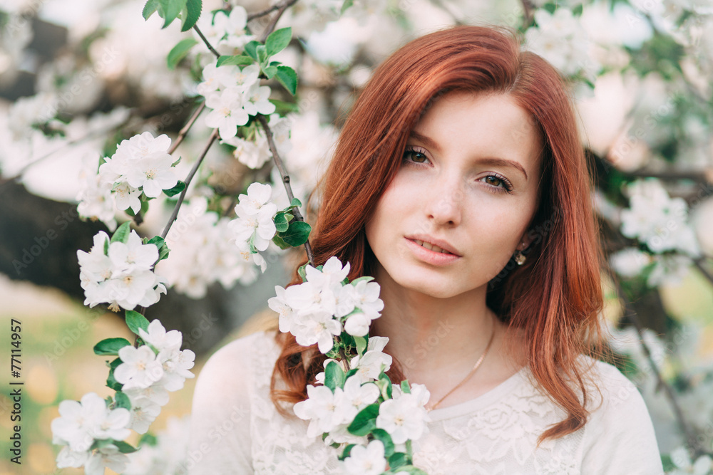 Young sensual redhead woman in a blossoming trees Young sensual redhead woman in a blossoming trees