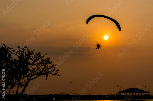silhouette of paramotor with sunset sky 