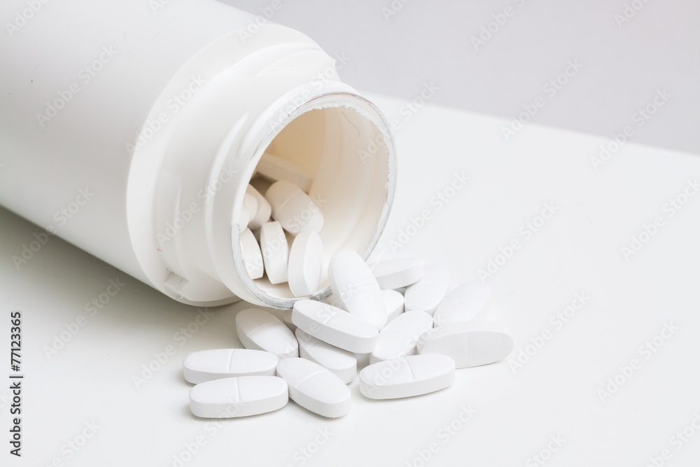 Pills and container. Isolated on white background. Pills and container. Isolated on white background.