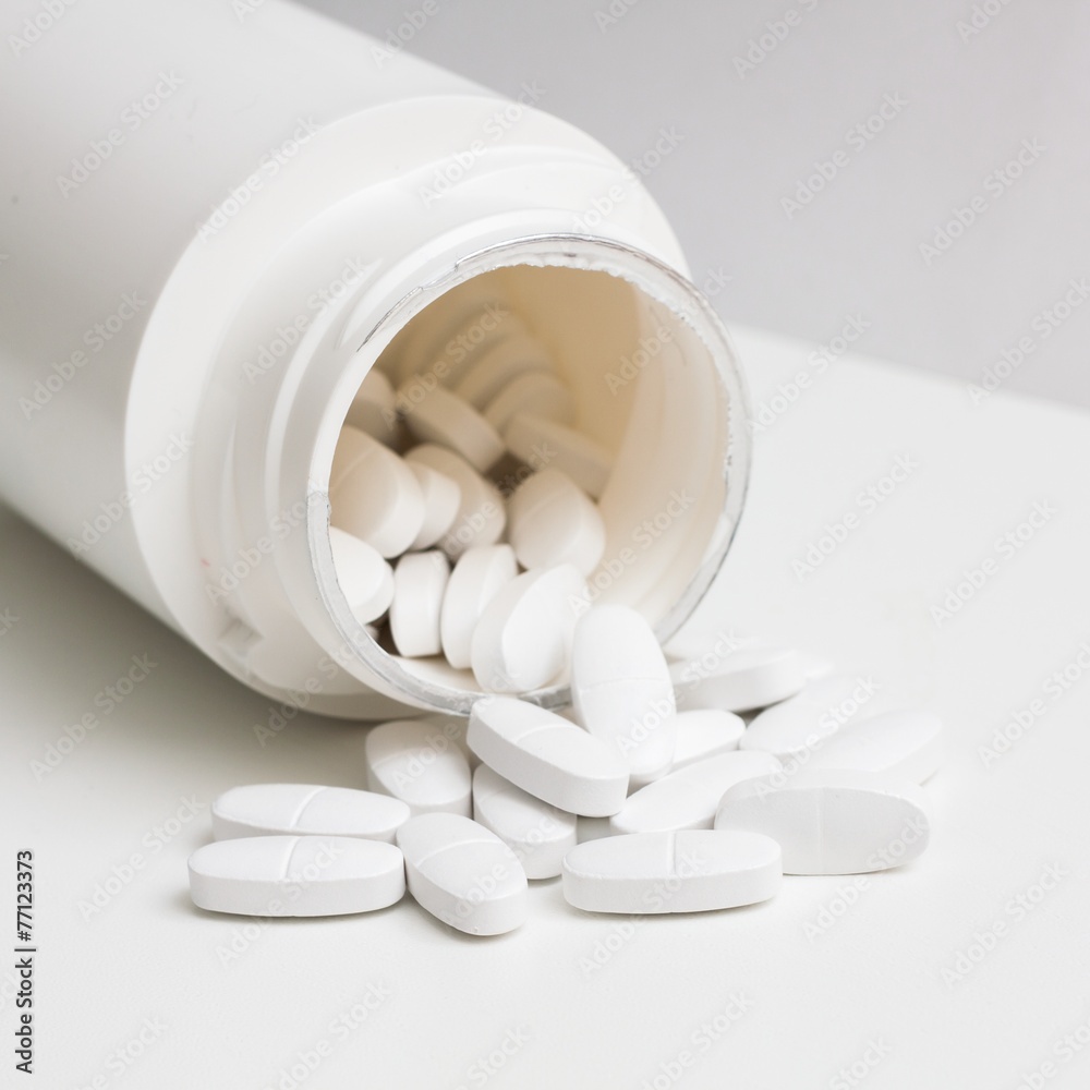 Pills and container. Isolated on white background. Pills and container. Isolated on white background.