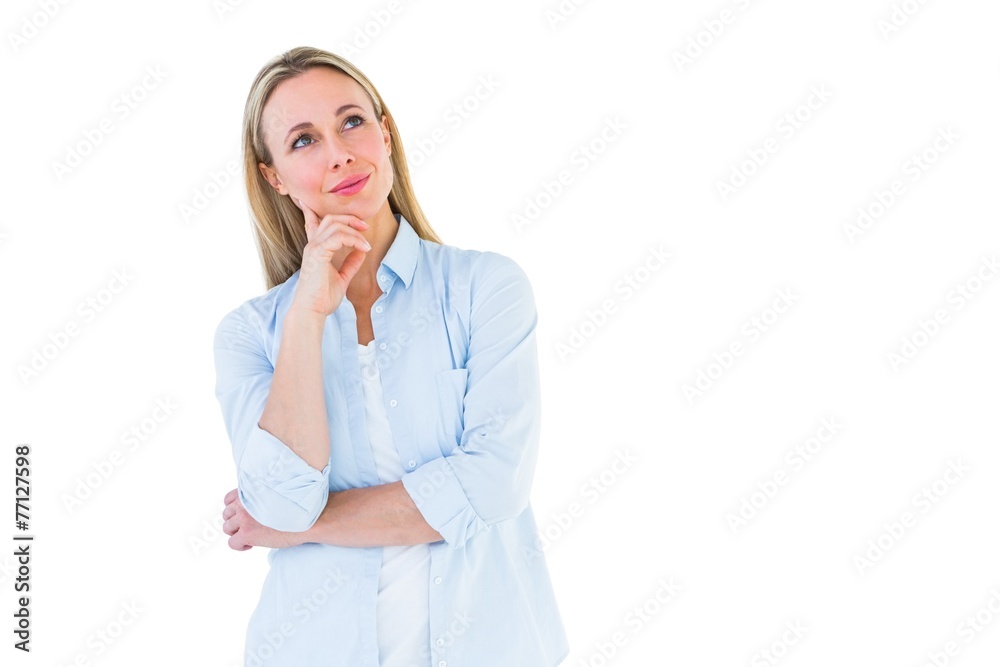 Smiling blonde thinking with hand on chin Smiling blonde thinking with hand on chin