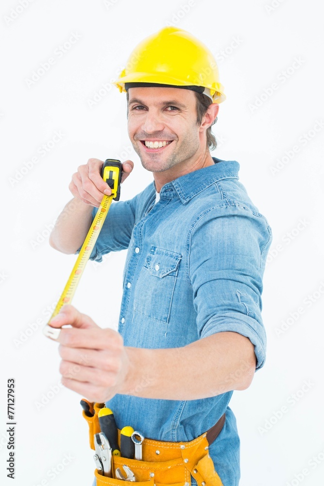 Happy male architect holding tape measure Happy male architect holding tape measure
