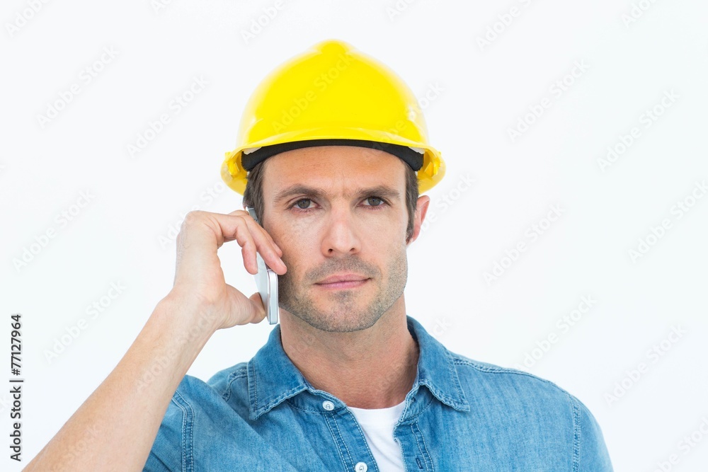 Serious carpenter using mobile phone Serious carpenter using mobile phone