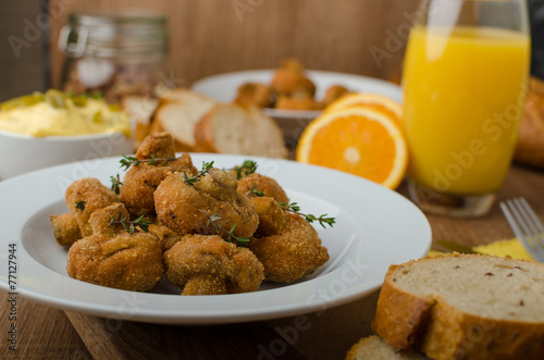 Breaded fried mushrooms with juice photo