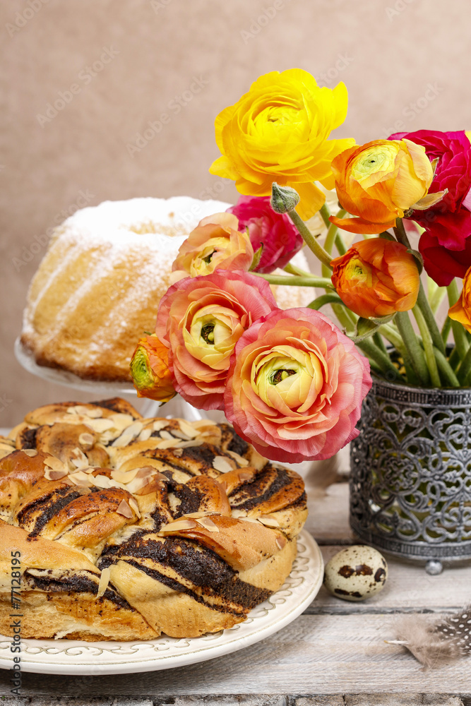Poppy seed easter cake and bouquet of ranunculus flowers