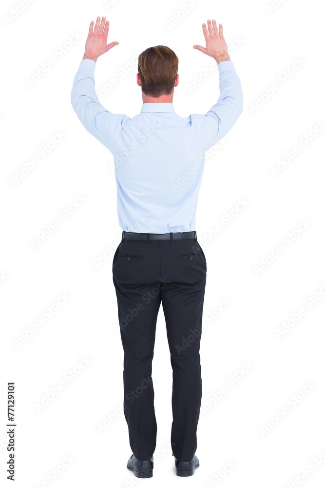 Rear view of businessman with hands up Rear view of businessman with hands up