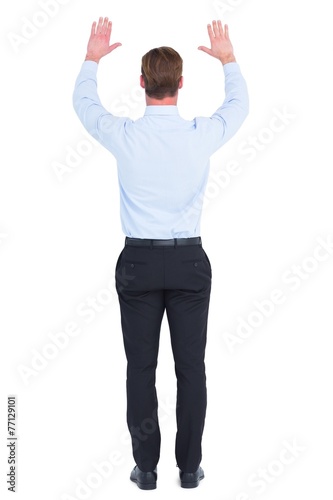 Rear view of businessman with hands up