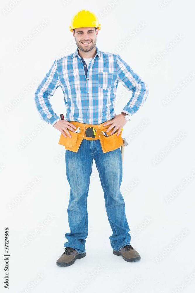 Confident repairman standing with hands on hips Confident repairman standing with hands on hips