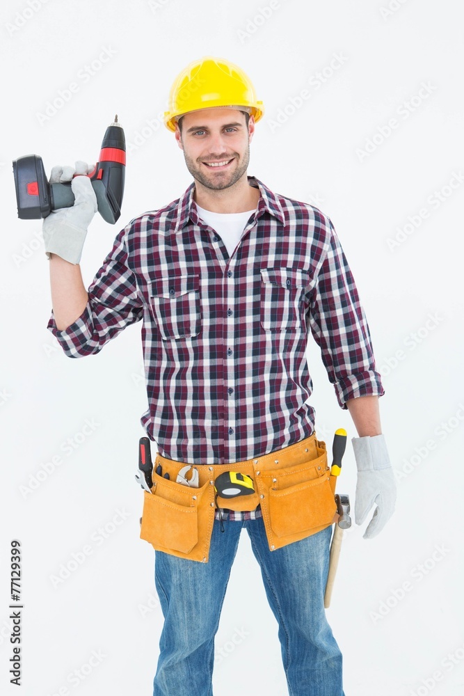 Confident male repairman holding drill machine Confident male repairman holding drill machine