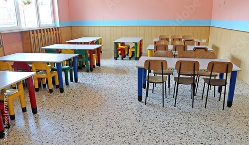 large refectory of kindergarten with tables and chairs photo