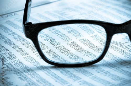 business financial newspaper report see through glasses lens