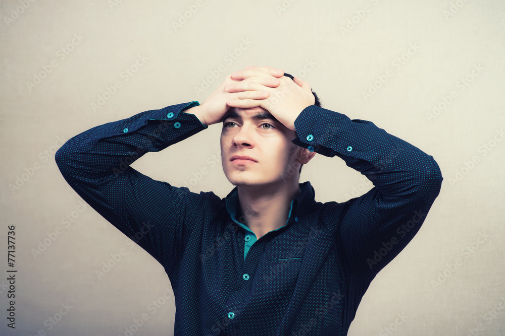 Frustrated businessman holding head in his hands