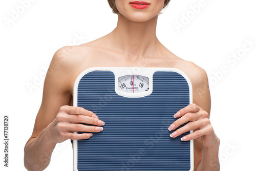 Close up portrait of woman holding weighs photo
