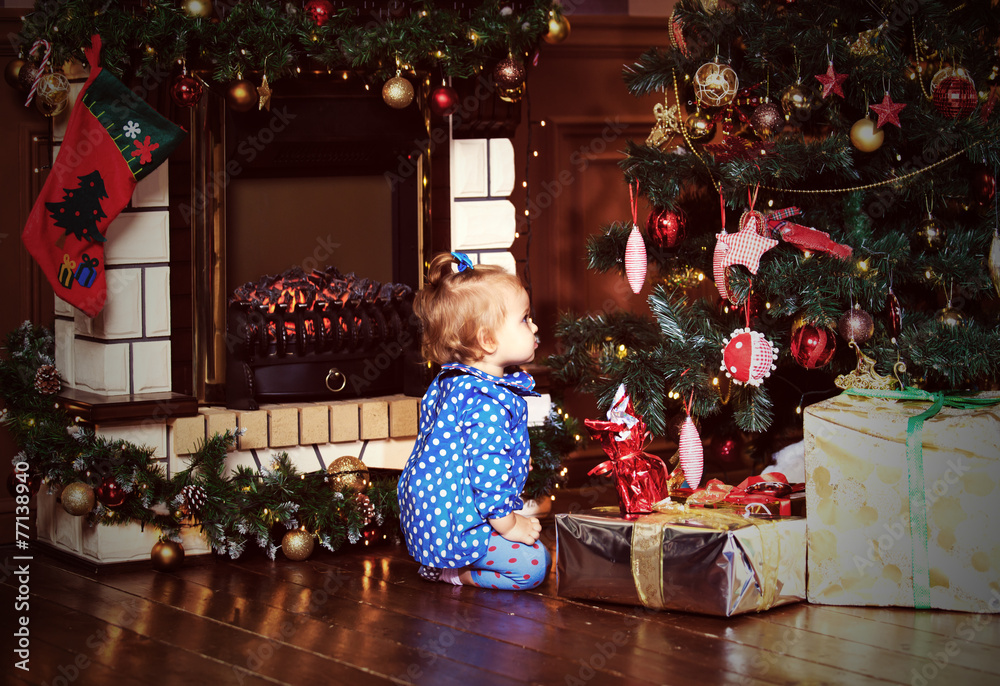 little girl with presents at christmas