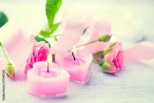 Valentines Day. Pink heart shaped candles and rose flowers