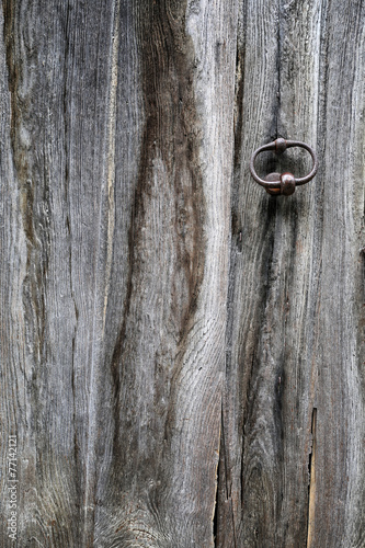 Fragment of an old wooden door with hardware elements