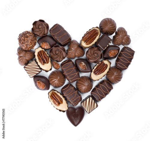 Heart shape made from various bonbons isolated on white