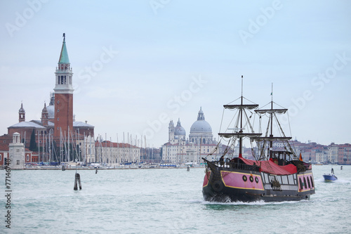 Galleass sailing in italian water canal photo