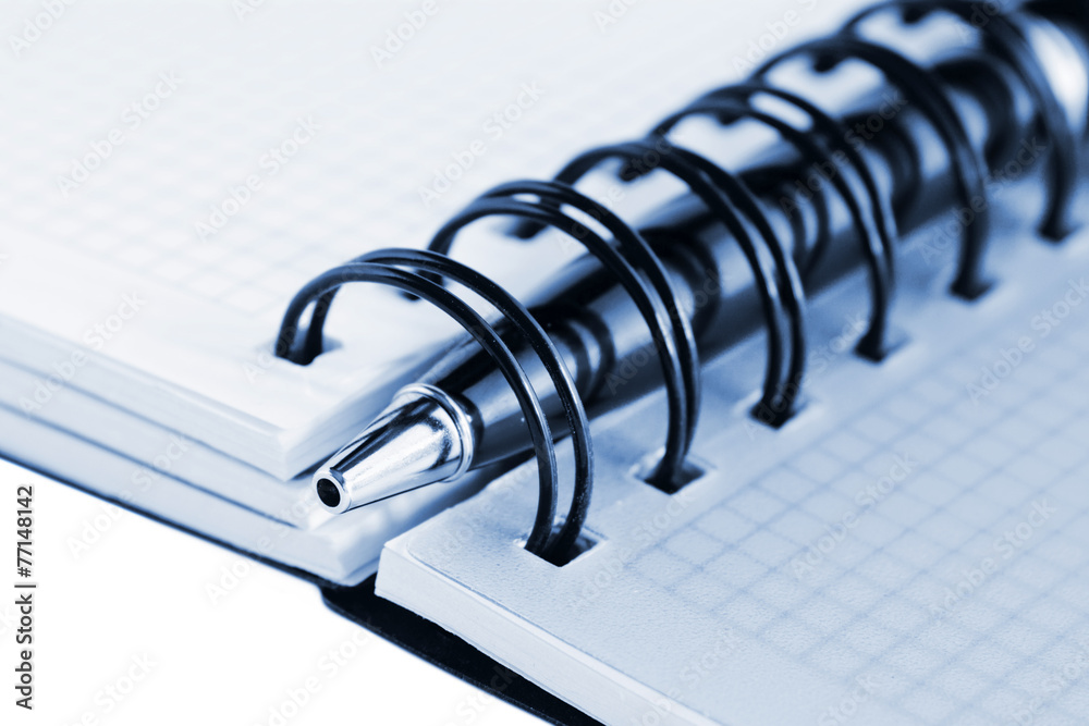 Open notebook and pen, with blue tint Open notebook and pen, with blue tint